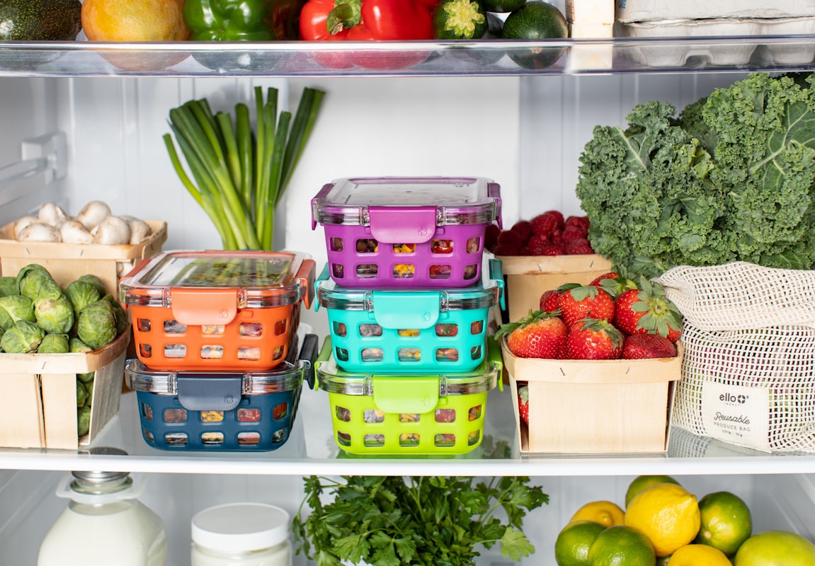 Meal planning workspace with fresh vegetables and meal containers